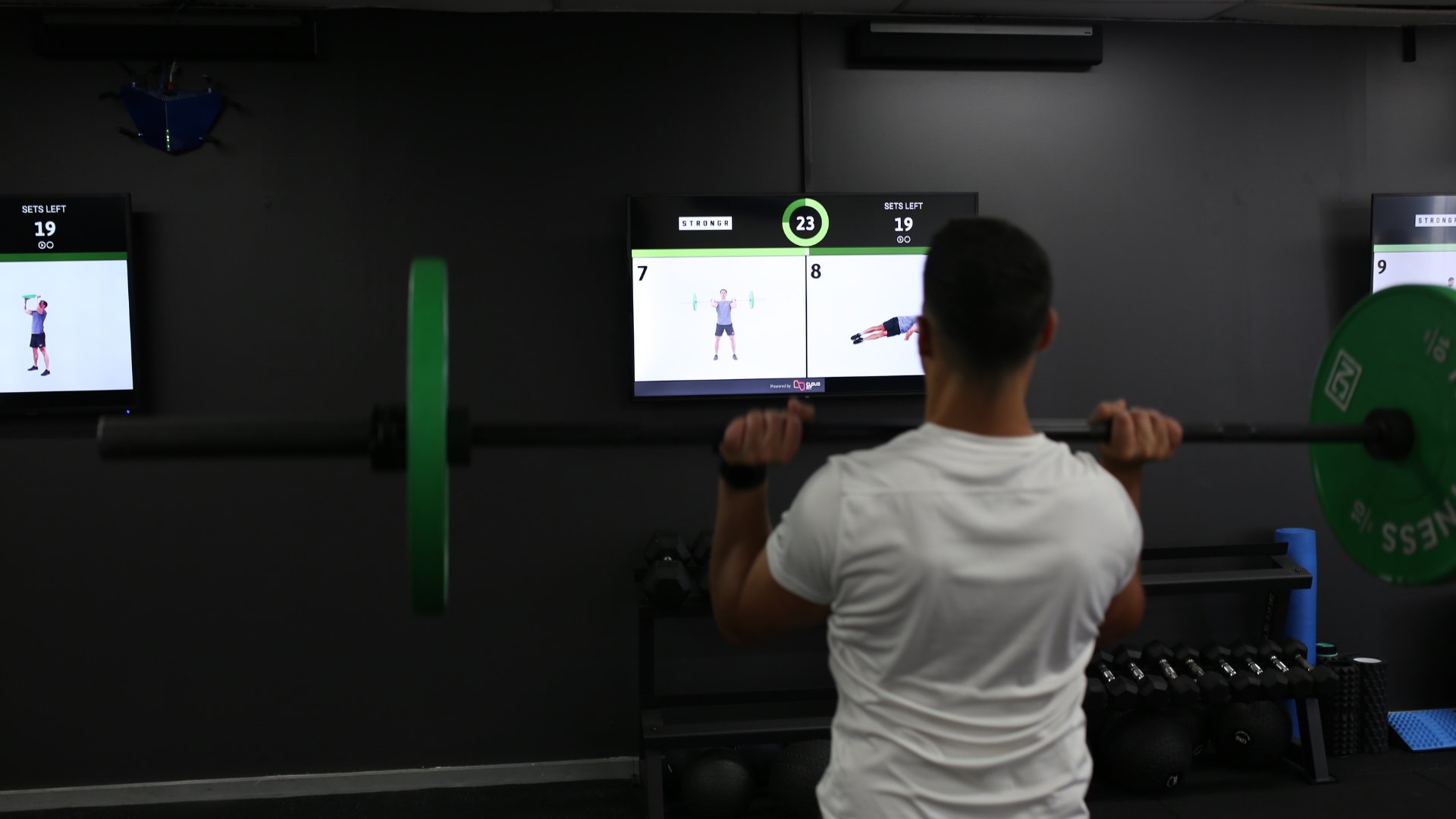 A class member following the CloudFit workout on screen