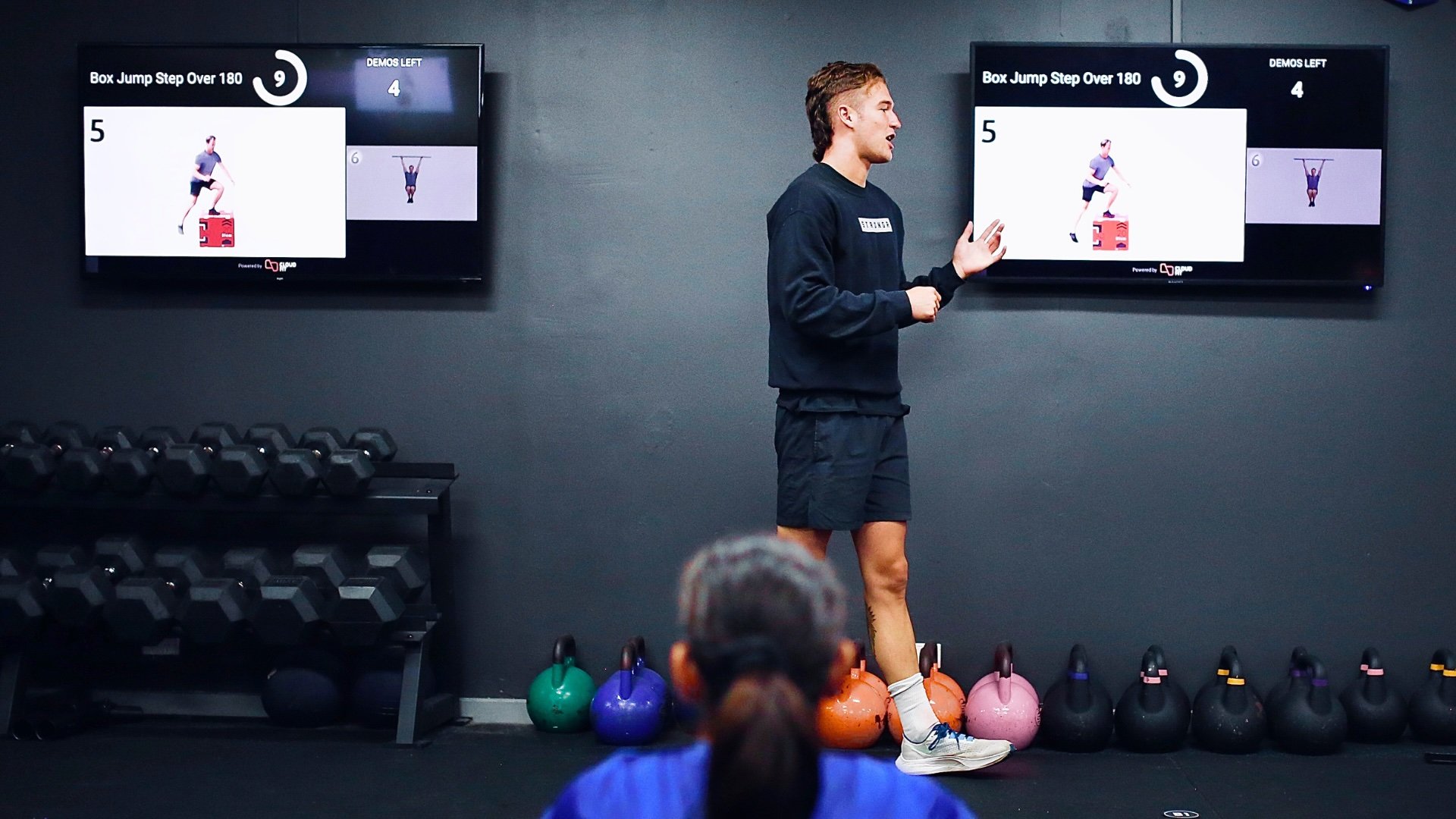 A coach explaining the workout to a class using CloudFit