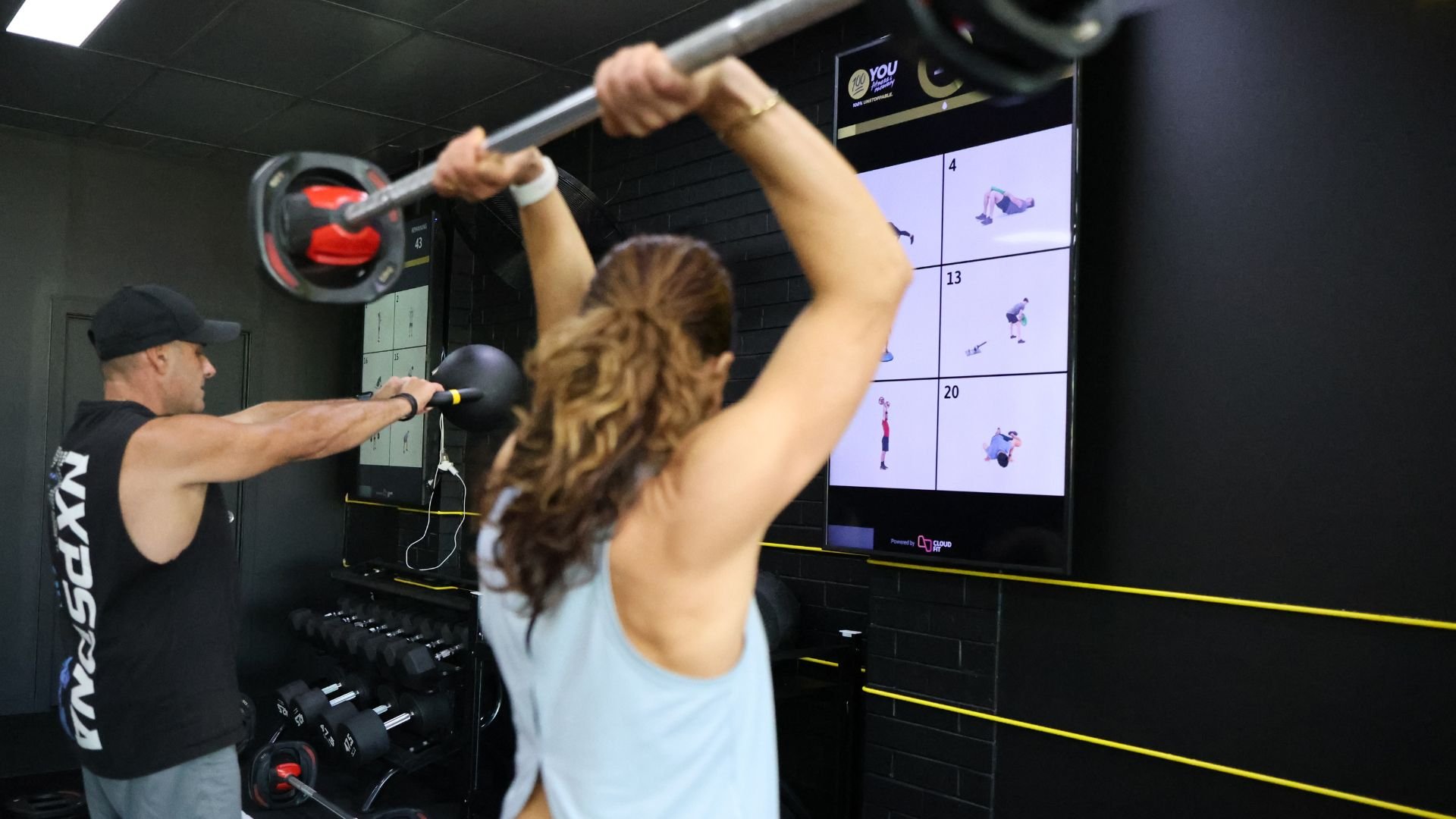 CloudFit running on TVs in portrait mode in a gym during a workout