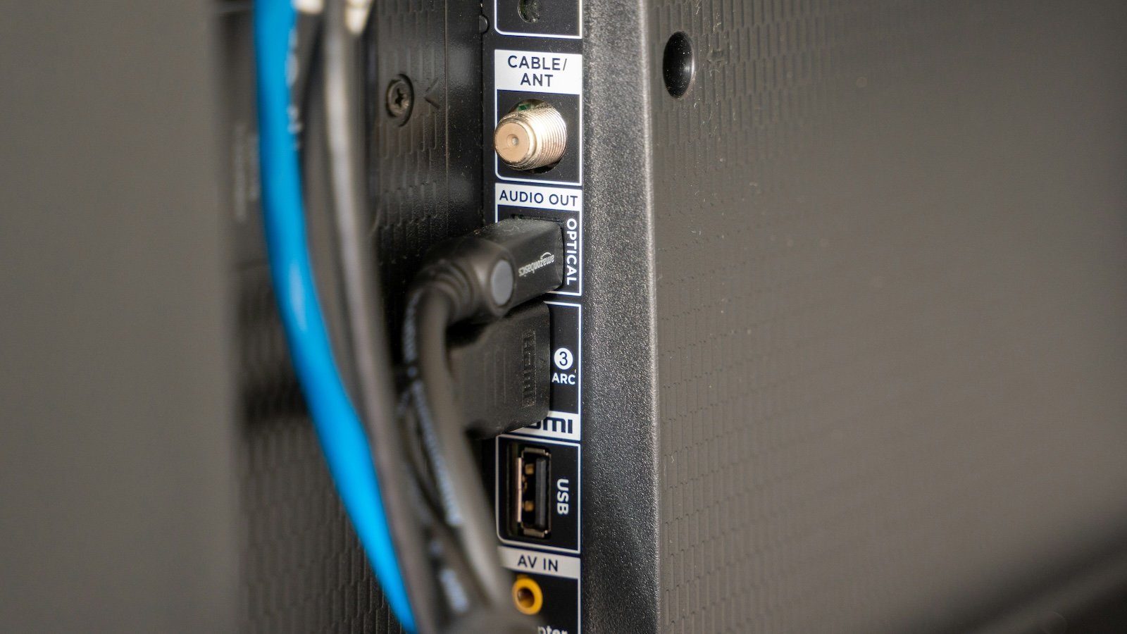 The back of a TV with HDMI and power cables