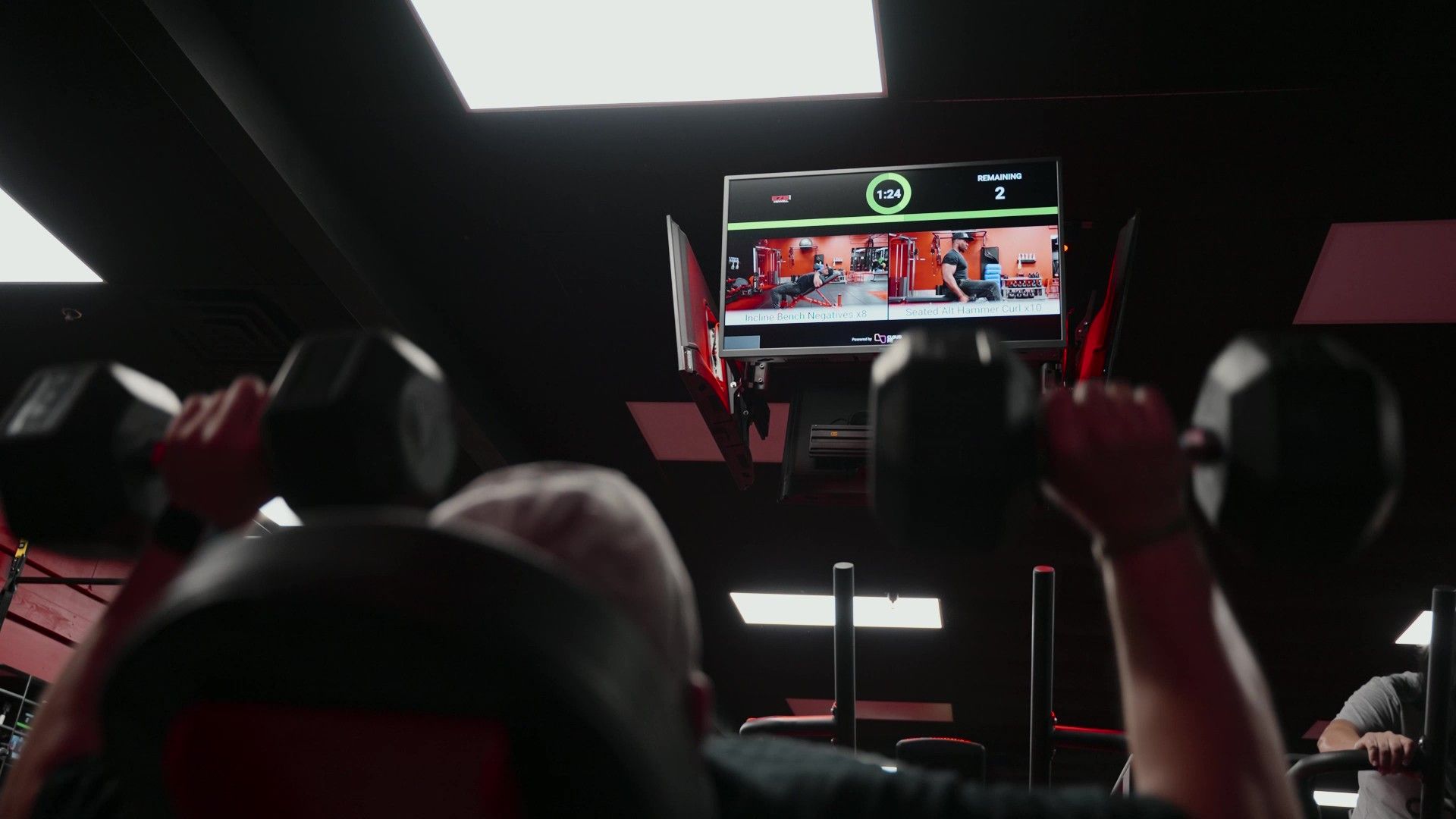 Coach leading a Strength & Conditioning class with CloudFit on screen